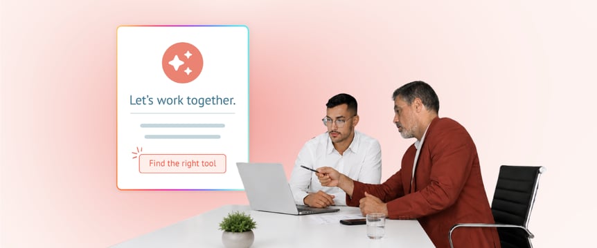 Two individuals at a desk looking at laptop