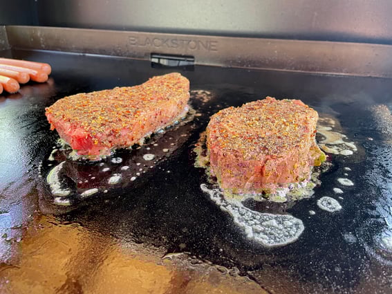 seared ribeyes on the flattop
