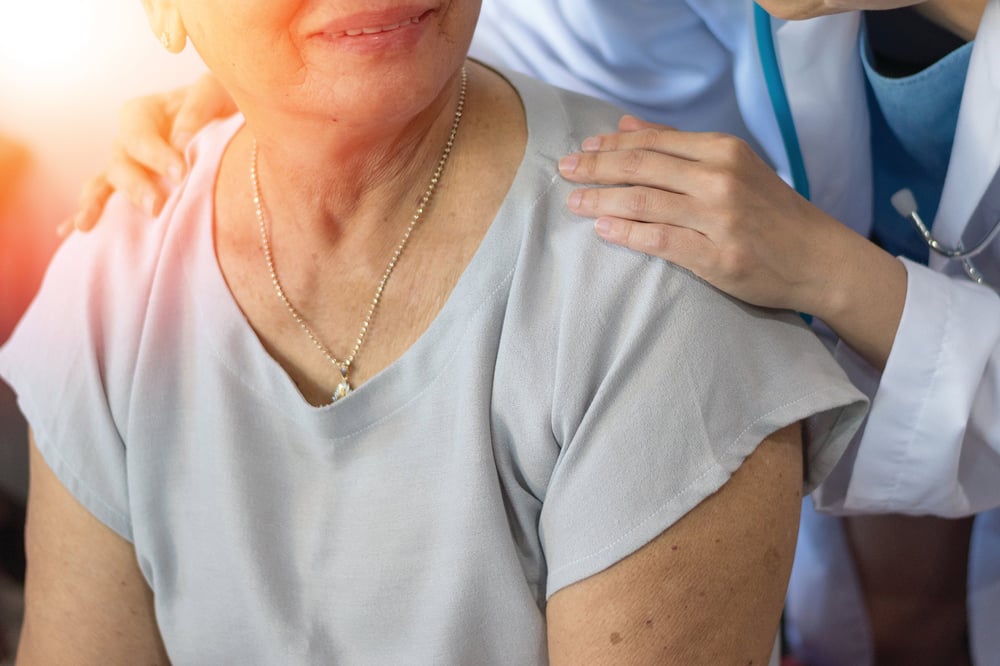 doctor with hands on patient shoulders-1