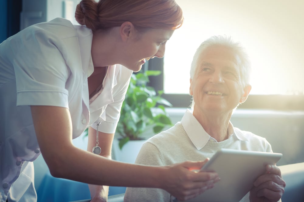 nurse with elderly man smiling