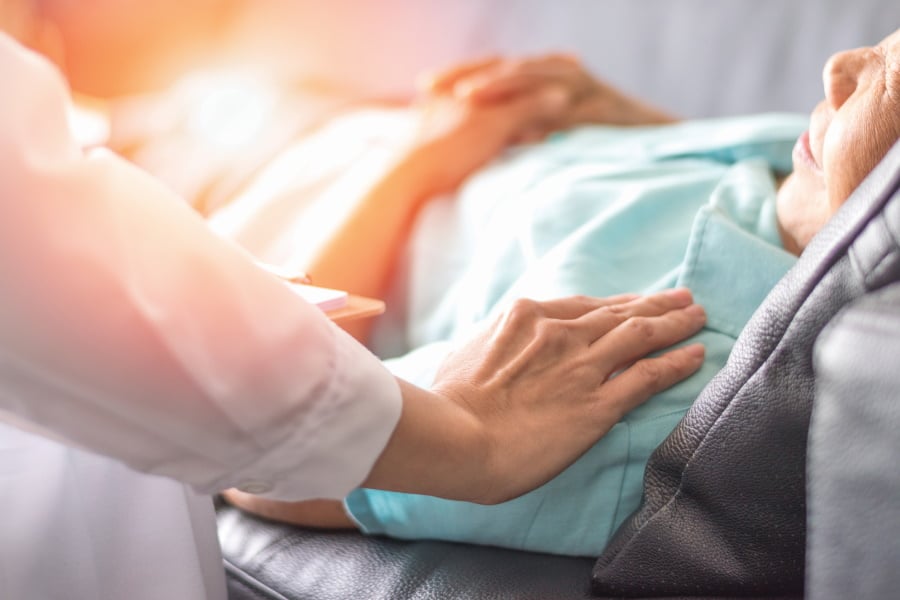 nurse with hands on patient